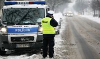 policjant drogówki w trakcie pomiaru prędkości zimą