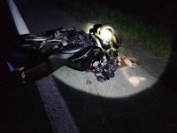 uszkodzony motocykl leży na jezdni- zdjęcie w nocy